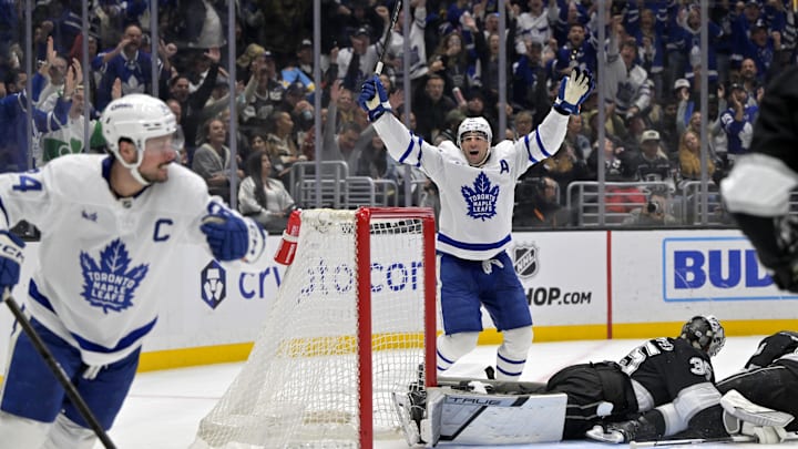 Mar 29, 2025; Los Angeles, California, USA; Los Angeles Kings goaltender Darcy Kuemper (35) and defenseman Mikey Anderson (44) look on as Toronto Maple Leafs center John Tavares (91) celebrates after scoring in the third period at Crypto.com Arena. Mandatory Credit: Jayne Kamin-Oncea-Imagn Images