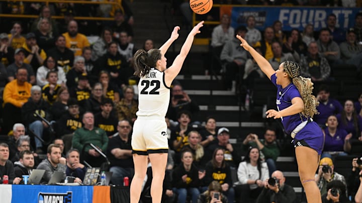Mar 23, 2024; Iowa City, IA, USA; Iowa Hawkeyes guard Caitlin Clark (22) shoots the ball as Holy Cross tries to defend the shot.