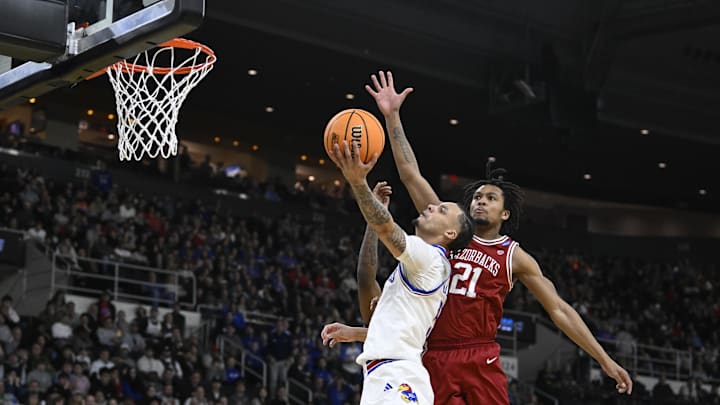 Mar 20, 2025; Providence, RI, USA;  Kansas Jayhawks guard Zeke Mayo (5) -shoots the ball against Arkansas Razorbacks guard D.J. Wagner (21) during the first quarter at Amica Mutual Pavilion. Mandatory Credit: Eric Canha-Imagn Images