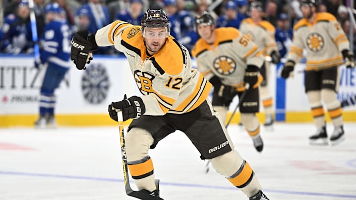 Dec 2, 2023; Toronto, Ontario, CAN; Boston Bruins defenseman Kevin Shattenkirk (12) pursues the puck against the Toronto Maple Leafs in the third period at Scotiabank Arena. Mandatory Credit: Dan Hamilton-Imagn Images