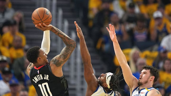 Apr 26, 2025; San Francisco, California, USA; Houston Rockets forward Jabari Smith Jr. (10) shoots against Golden State Warriors guard Buddy Hield (7) and center Quinten Post (right) during the first quarter of game three of first round for the 2024 NBA Playoffs at Chase Center. Mandatory Credit: Darren Yamashita-Imagn Images
