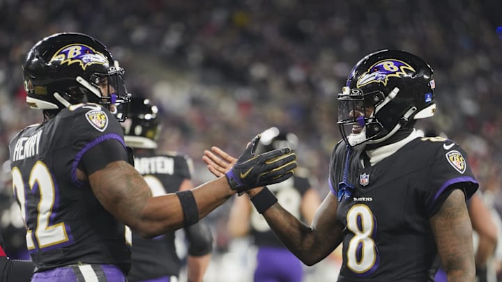Dec 21, 2025; Baltimore, Maryland, USA;  Baltimore Ravens quarterback Lamar Jackson (8) congratulates running back Derrick Henry (22) on a touchdown run against the New England Patriots during the first quarter at M&T Bank Stadium. Mandatory Credit: Mitch Stringer-Imagn Images