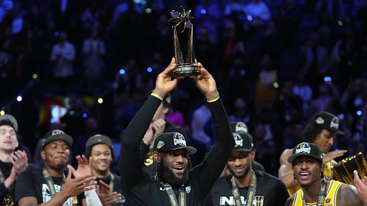 Los Angeles forward LeBron James celebrates with the MVP trophy after the Lakers beat the Indiana Pacers to win the NBA's first in-season tournament championship in 2023.