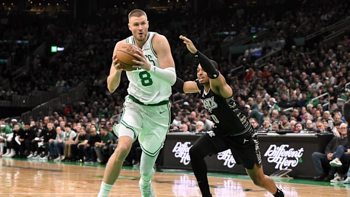 Feb 12, 2025; Boston, Massachusetts, USA; Boston Celtics center Kristaps Porzingis (8) drives to the basket against San Antonio Spurs forward Keldon Johnson (0) during the second quarter at the TD Garden. Mandatory Credit: Brian Fluharty-Imagn Images