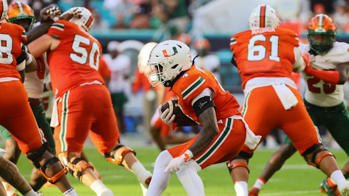 Sep 7, 2024; Miami Gardens, Florida, USA; Miami Hurricanes running back Mark Fletcher Jr. (4) runs with the football against the Florida A&M Rattlers during the first quarter at Hard Rock Stadium. Mandatory Credit: Sam Navarro-Imagn Images