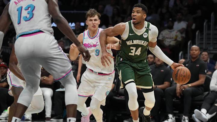 Apr 5, 2025; Miami, Florida, USA;  Milwaukee Bucks forward Giannis Antetokounmpo (34) looks to pass the ball as Miami Heat guard Pelle Larsson (9) defends during the second half at Kaseya Center. Mandatory Credit: Jim Rassol-Imagn Images