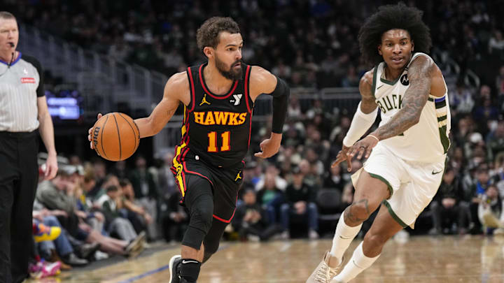 Mar 30, 2025; Milwaukee, Wisconsin, USA;  Atlanta Hawks guard Trae Young (11) drives for the basket in front of Milwaukee Bucks guard Kevin Porter Jr. (3) during the fourth quarter at Fiserv Forum. Mandatory Credit: Jeff Hanisch-Imagn Images
