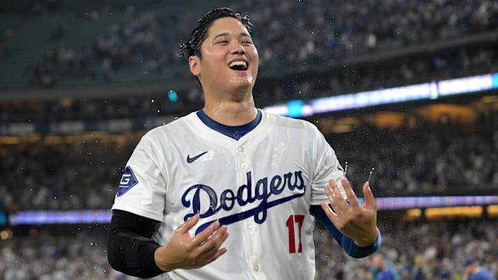 Aug 23, 2024; Los Angeles, California, USA;  Los Angeles Dodgers designated hitter Shohei Ohtani (17) smiles after he was doused with ice water after hitting a walk-off grand slam home run, his 40th of the season, in the ninth inning against the Tampa Bay Rays at Dodger Stadium. Watson. Mandatory Credit: Jayne Kamin-Oncea-Imagn Images