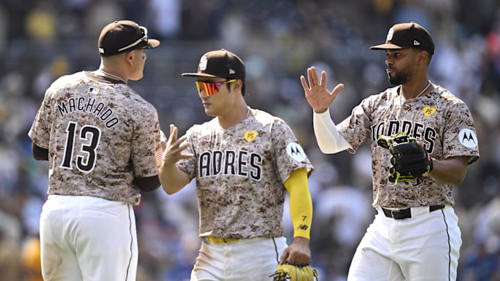 Apr 21, 2024; San Diego, California, USA; San Diego Padres second baseman Xander Bogaerts (right) and shortstop Ha-Seong Kim (7) celebrate on the field with designated hitter Manny Machado (13) after defeating the Toronto Blue Jays at Petco Park. Mandatory Credit: Orlando Ramirez-Imagn Images