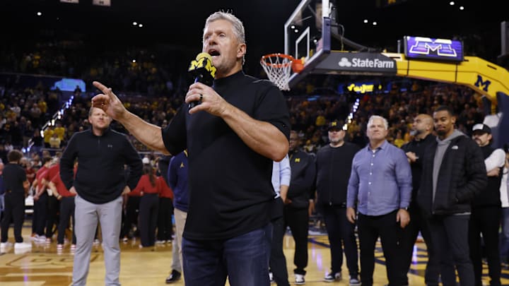 Jan 2, 2026; Ann Arbor, Michigan, USA;  Michigan Wolverines football head coach Kyle Whittingham speaks to the crowd during a time out in the first half against the Southern California Trojans at Crisler Center. Mandatory Credit: Rick Osentoski-Imagn Images