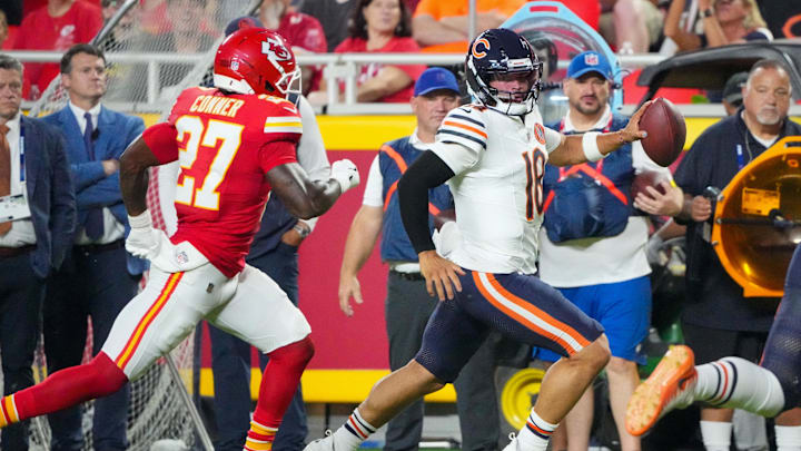 Chicago Bears quarterback Caleb Williams (18) runs the ball as Kansas City Chiefs safety Chamarri Conner (27) chases