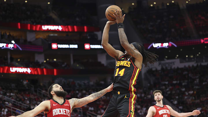 Mar 25, 2025; Houston, Texas, USA; Atlanta Hawks guard Terance Mann (14) shoots the ball over Houston Rockets guard Fred VanVleet (5) during the fourth quarter at Toyota Center. Mandatory Credit: Troy Taormina-Imagn Images