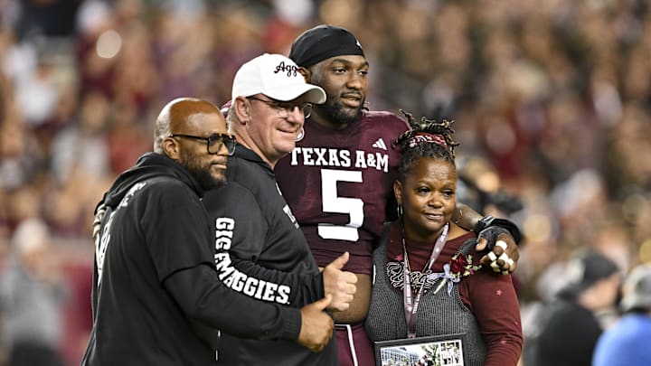 Nov 16, 2024; College Station, Texas, USA; Texas A&M Aggies defensive lineman Shemar Turner (5) poses for a picture with family and head coach Mike Elko prior to the game against the New Mexico State Aggies at Kyle Field. Mandatory Credit: Maria Lysaker-Imagn Images 