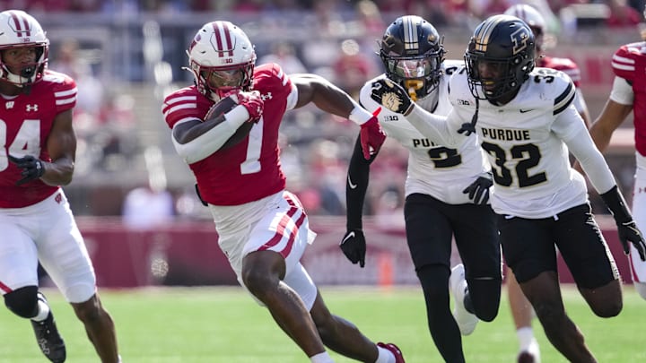 Oct 5, 2024; Madison, Wisconsin, USA;  Wisconsin Badgers running back Dilin Jones (7) rushes with the football after catching a pass during the fourth quarter against the Purdue Boilermakers at Camp Randall Stadium. Mandatory Credit: Jeff Hanisch-Imagn Images
