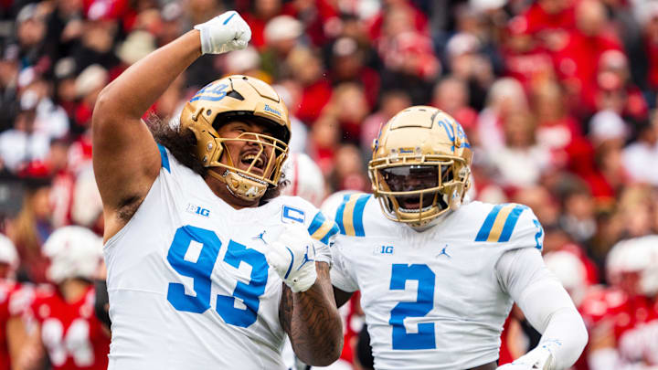 Nov 2, 2024; Lincoln, Nebraska, USA; UCLA Bruins defensive lineman Jay Toia (93) and linebacker Oluwafemi Oladejo (2) celebrate after a sack against the Nebraska Cornhuskers during the first quarter at Memorial Stadium. Mandatory Credit: Dylan Widger-Imagn Images Nov 2, 2024; Lincoln, Nebraska, USA; UCLA Bruins defensive lineman Jay Toia (93) and linebacker Oluwafemi Oladejo (2) celebrate after a sack against the Nebraska Cornhuskers during the first quarter at Memorial Stadium. Mandatory Credit: Dylan Widger-Imagn Images