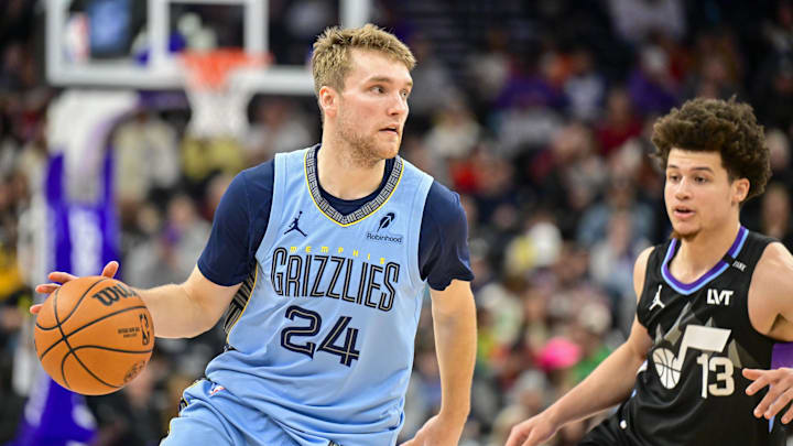 Dec 23, 2025; Salt Lake City, Utah, USA; Memphis Grizzlies guard Cam Spencer (24) looks to pass around Utah Jazz guard Walter Clayton Jr. (13) during the first half at Delta Center. Mandatory Credit: Peter Creveling-Imagn Images