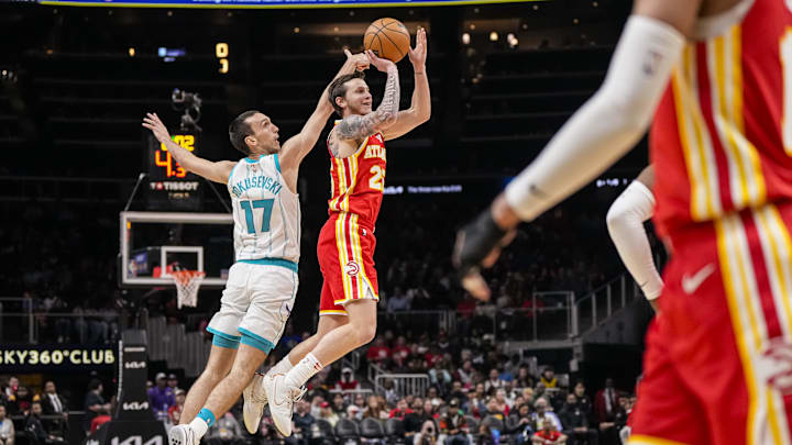 Apr 10, 2024; Atlanta, Georgia, USA; Atlanta Hawks guard Garrison Mathews (25) shoots behind Charlotte Hornets forward Aleksej Pokusevski (17) during the first half at State Farm Arena. Mandatory Credit: Dale Zanine-Imagn Images