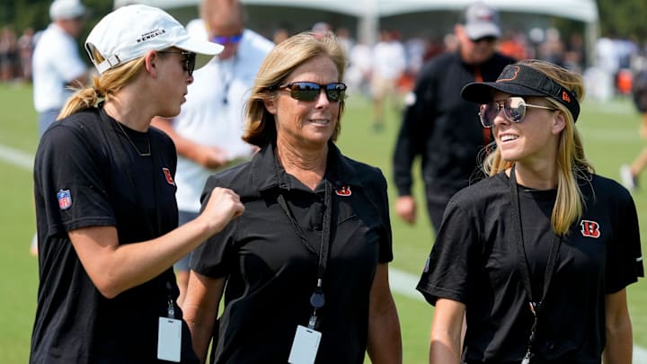 Bengals executive Vice President Katie Blackburn (center) walks off the practice field with her daughters Caroline and Elizabeth during a training camp practice at the Paycor Stadium practice facility in downtown Cincinnati on Tuesday, Aug. 1, 2023. Tuesday marked the team’s first preseason practice in pads.