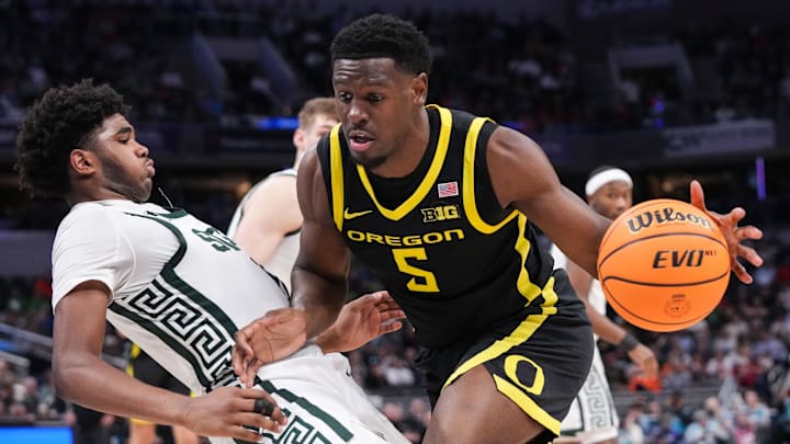Oregon Ducks guard TJ Bamba (5) rushes up the court against Michigan State Spartans guard Jase Richardson (11) on Friday, March 14, 2025, during the third round of the men's Big Ten tournament at Gainbridge Fieldhouse in Indianapolis. Oregon Ducks guard TJ Bamba (5) rushes up the court against Michigan State Spartans guard Jase Richardson (11) on Friday, March 14, 2025, during the third round of the men's Big Ten tournament at Gainbridge Fieldhouse in Indianapolis.