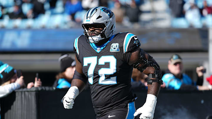 Dec 22, 2024; Charlotte, North Carolina, USA; Carolina Panthers offensive tackle Taylor Moton (72) takes the field during the first quarter against the Arizona Cardinals at Bank of America Stadium. Mandatory Credit: Jim Dedmon-Imagn Images