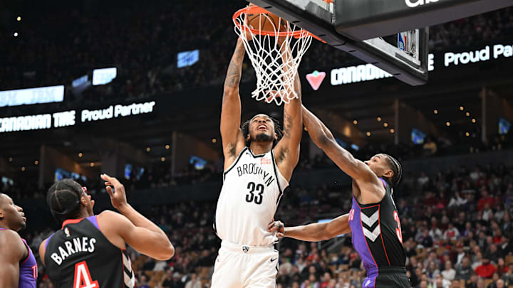 Nic Claxton tips in a rebound during the Nets' game against the Raptors on Dec. 19, 2024.