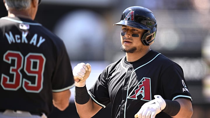 Jul 7, 2024; San Diego, California, USA; Arizona Diamondbacks catcher Gabriel Moreno (14) celebrates with first base coach Dave McKay (39) after hitting an RBI single against the San Diego Padres during the eighth inning at Petco Park. Mandatory Credit: Orlando Ramirez-Imagn Images Jul 7, 2024; San Diego, California, USA; Arizona Diamondbacks catcher Gabriel Moreno (14) celebrates with first base coach Dave McKay (39) after hitting an RBI single against the San Diego Padres during the eighth inning at Petco Park. Mandatory Credit: Orlando Ramirez-Imagn Images