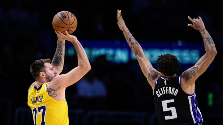 Oct 17, 2025; Los Angeles, California, USA; Los Angeles Lakers forward/guard Luka Doncic (77) shoots over Sacramento Kings guard Nique Clifford (5) during the first half at Crypto.com Arena. Mandatory Credit: William Liang-Imagn Images Oct 17, 2025; Los Angeles, California, USA; Los Angeles Lakers forward/guard Luka Doncic (77) shoots over Sacramento Kings guard Nique Clifford (5) during the first half at Crypto.com Arena. Mandatory Credit: William Liang-Imagn Images