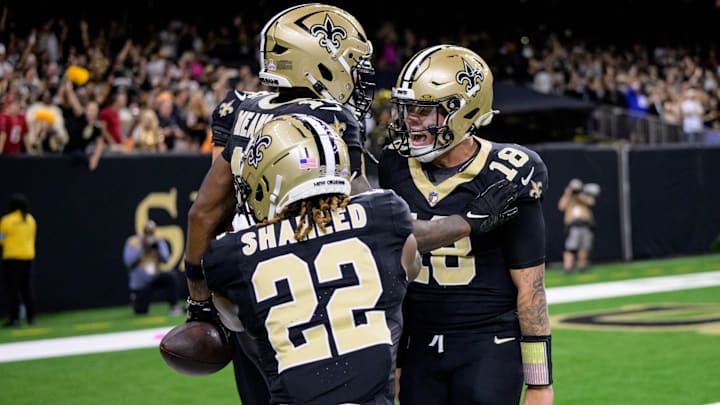 Oct 13, 2024; New Orleans, Louisiana, USA; New Orleans Saints quarterback Spencer Rattler (18) celebrates a touchdown by New Orleans Saints wide receiver Bub Means (16) with New Orleans Saints wide receiver Rashid Shaheed (22) during the second quarter against the Tampa Bay Buccaneers at Caesars Superdome. Mandatory Credit: Matthew Hinton-Imagn Images