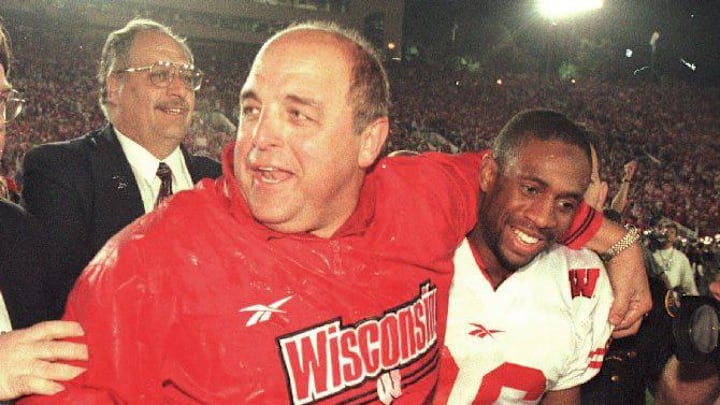 Wisconsin Badgers football coach Barry Alvarez hugs defensive back MIke Echols after being dunked with water after the Badgers beat the UCLA Bruins in the rose bowl on Jan, 1,1998.