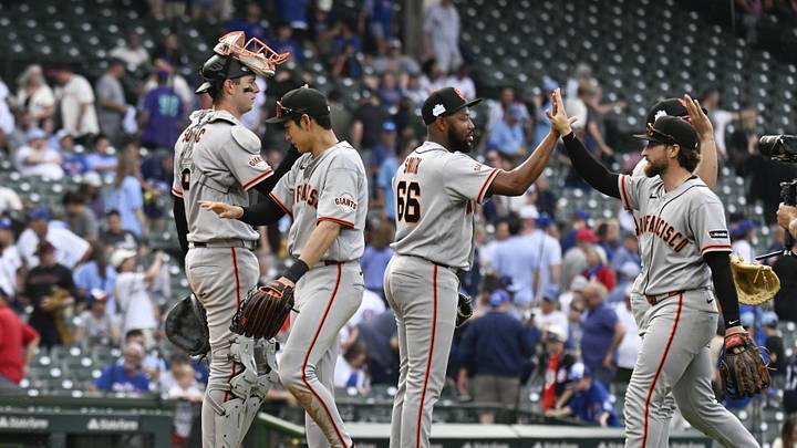 San Francisco Giants players high five after the game against the Chicago Cubs at Wrigley Field.