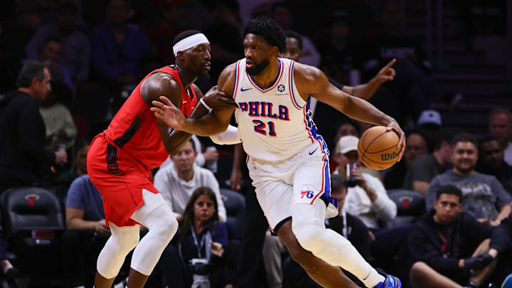 Nov 18, 2024; Miami, Florida, USA; Philadelphia 76ers center Joel Embiid (21) drives to the basket against Miami Heat center Bam Adebayo (13) during the first quarter at Kaseya Center. Mandatory Credit: Sam Navarro-Imagn Images