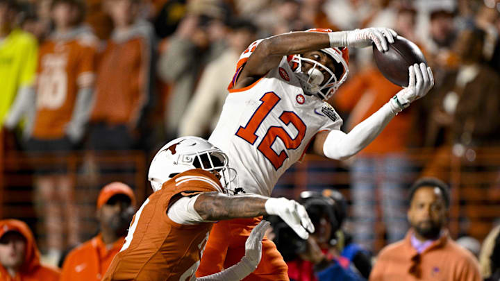 Dec 21, 2024; Austin, Texas, USA; Clemson Tigers wide receiver Bryant Wesco Jr. (12) attempts to catch a pass of Texas Longhorns defensive back Gavin Holmes (9) during the second half of the CFP National Playoff first round game at Darrell K Royal-Texas Memorial Stadium. Mandatory Credit: Jerome Miron-Imagn Images