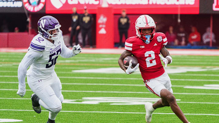 Oct 25, 2025; Lincoln, Nebraska, USA; Nebraska Cornhuskers wide receiver Jacory Barney Jr. (2) runs with the ball against Northwestern Wildcats defensive lineman Richie Hagarty (52) during the second quarter at Memorial Stadium. 
