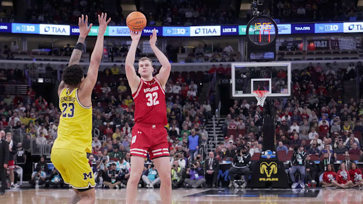 Wisconsin forward Aleksas Bieliauskas (32) hits a three-point basket over Michigan forward Yaxel Lendeborg (23) during the first half of their semifinal game in the Big Ten tournament Saturday, March 14, 2026 at the United Center in Chicago, Illinois.
