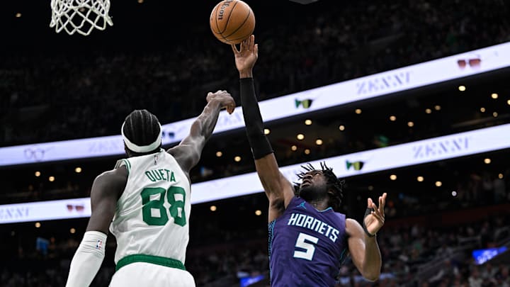 Apr 11, 2025; Boston, Massachusetts, USA; Charlotte Hornets center Mark Williams (5) shoots over Boston Celtics center Neemias Queta (88) during the second half at TD Garden. Mandatory Credit: Eric Canha-Imagn Images