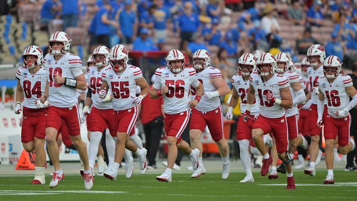 Wisconsin Badgers players run on to the field against the UCLA Bruins at the Rose Bowl Wisconsin Badgers players run on to the field against the UCLA Bruins at the Rose Bowl