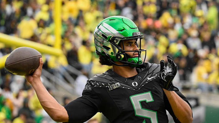 Oct 11, 2025; Eugene, Oregon, USA; Oregon Ducks quarterback Dante Moore (5) throws a pass before the game against the Indiana Hoosiers at Autzen Stadium. Mandatory Credit: Troy Wayrynen-Imagn Images Oct 11, 2025; Eugene, Oregon, USA; Oregon Ducks quarterback Dante Moore (5) throws a pass before the game against the Indiana Hoosiers at Autzen Stadium. Mandatory Credit: Troy Wayrynen-Imagn Images