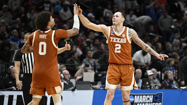 Texas Longhorns guard Chendall Weaver celebrates with guard Jordan Pope in the second half against the BYU Cougars during a first round game of the men's 2026 NCAA Tournament at Moda Center. Texas Longhorns guard Chendall Weaver celebrates with guard Jordan Pope in the second half against the BYU Cougars during a first round game of the men's 2026 NCAA Tournament at Moda Center.