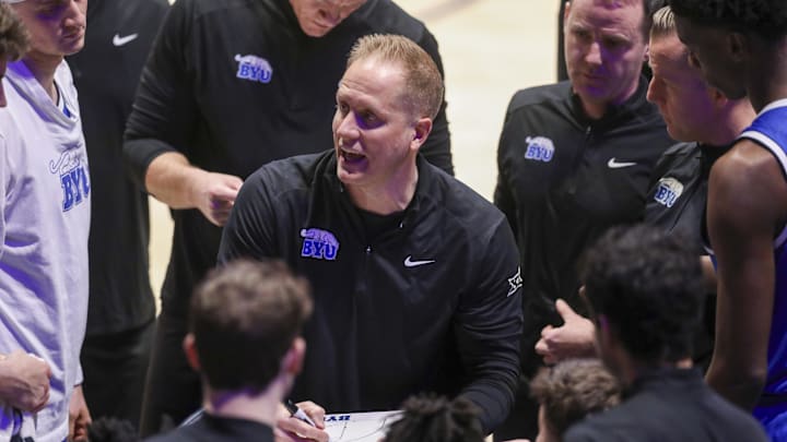Feb 28, 2026; Morgantown, West Virginia, USA; BYU Cougars head coach Kevin Young talks to his team during a timeout during the second half against the West Virginia Mountaineers at Hope Coliseum. Mandatory Credit: Ben Queen-Imagn Images Feb 28, 2026; Morgantown, West Virginia, USA; BYU Cougars head coach Kevin Young talks to his team during a timeout during the second half against the West Virginia Mountaineers at Hope Coliseum. Mandatory Credit: Ben Queen-Imagn Images