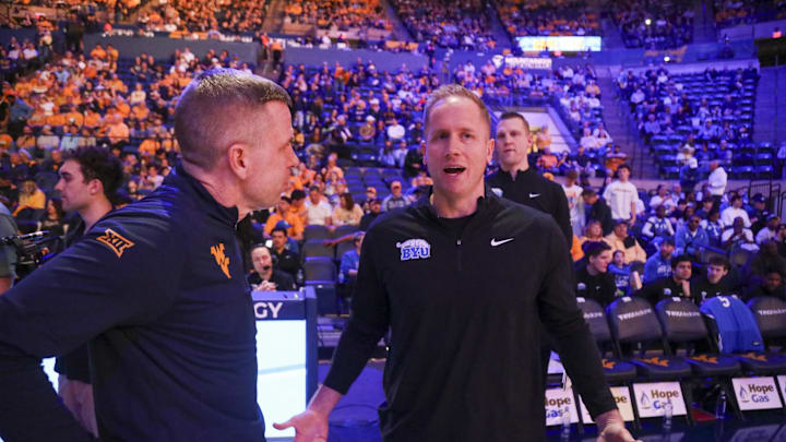 Feb 28, 2026; Morgantown, West Virginia, USA; BYU Cougars head coach Kevin Young talks with West Virginia Mountaineers head coach Ross Hodge before the game at Hope Coliseum. Mandatory Credit: Ben Queen-Imagn Images