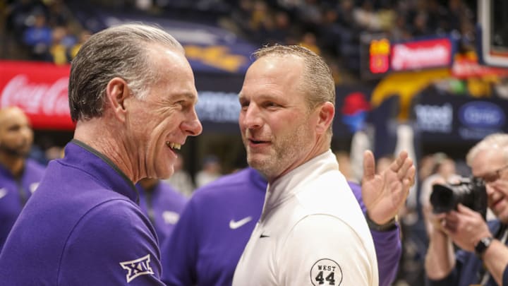 Feb 25, 2025; Morgantown, West Virginia, USA; West Virginia Mountaineers head coach Darian DeVries talks with TCU Horned Frogs head coach Jamie Dixon before their game at WVU Coliseum. Mandatory Credit: Ben Queen-Imagn Images