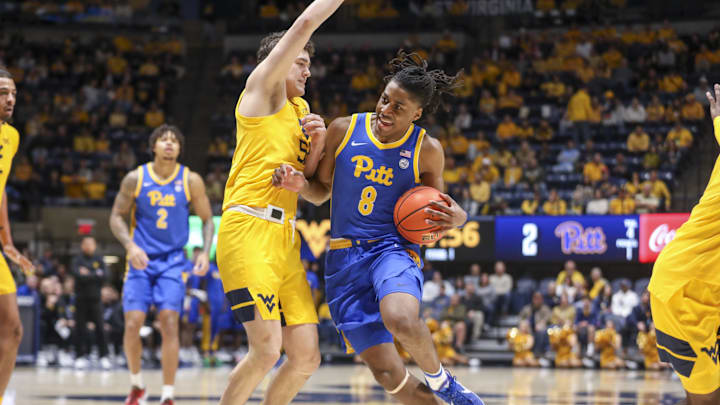 Nov 13, 2025; Morgantown, West Virginia, USA; Pittsburgh Panthers guard Omari Witherspoon (8) drives against West Virginia Mountaineers guard Treysen Eaglestaff (52) during the first half at WVU Coliseum. Mandatory Credit: Ben Queen-Imagn Images