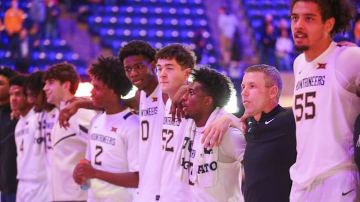 Dec 9, 2025; Morgantown, West Virginia, USA; West Virginia Mountaineers players celebrate after defeating the Little Rock Trojans at Hope Coliseum. Mandatory Credit: Ben Queen-Imagn Images