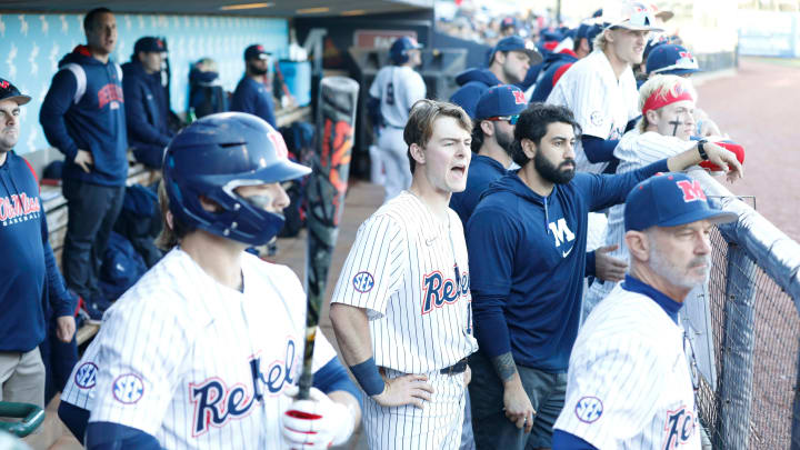 University of Mississippi baseball players watch their teammates from their dugout during a game.