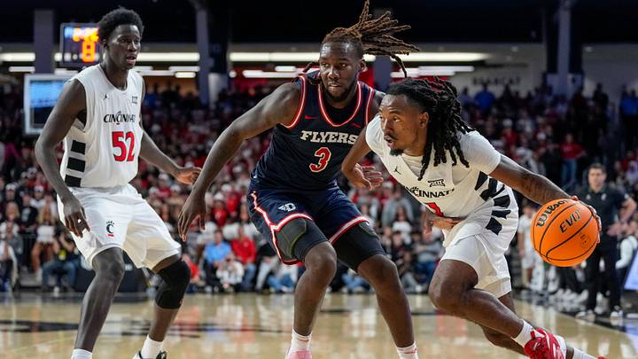 Cincinnati Bearcats guard Day Day Thomas (1) drives against Dayton Flyers forward Jaiun Simon (3) in the first half of the NCAA Men’s Basketball game between the Cincinnati Bearcats and the Dayton Flyers at Fifth Third Arena in Cincinnati on Tuesday, Nov. 11, 2025.
