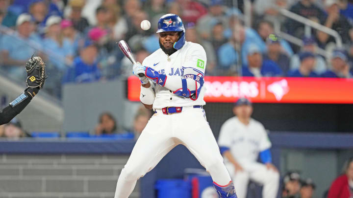 Jun 30, 2024; Toronto, Ontario, CAN; Toronto Blue Jays first base Vladimir Guerrero Jr. (27) gets hit with a pitch against the New York Yankees during the third inning at Rogers Centre. Jun 30, 2024; Toronto, Ontario, CAN; Toronto Blue Jays first base Vladimir Guerrero Jr. (27) gets hit with a pitch against the New York Yankees during the third inning at Rogers Centre.