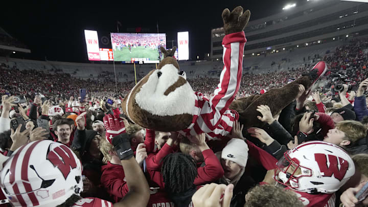 Bucky Badger crowds surfs after fans stormed the field after the Wisconsin Illinois football game Saturday, November 22, 2025, at Camp Randall Stadium in Madison, Wisconsin. Wisconsin beat Illinois 27-10.