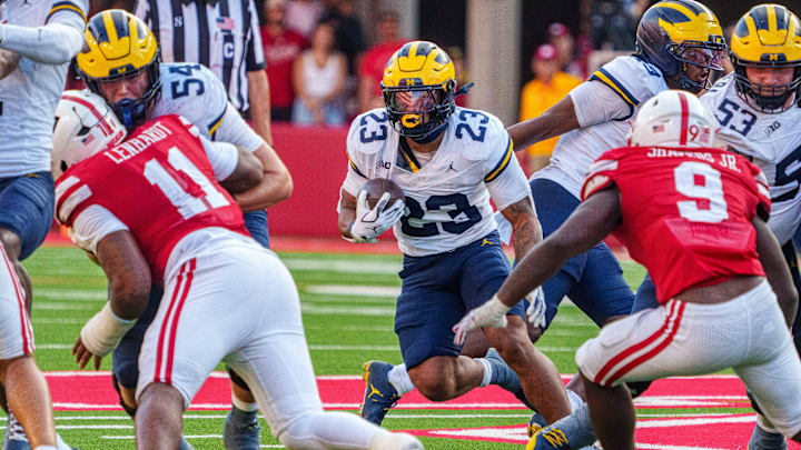 Michigan Wolverines running back Jordan Marshall (23) runs against Nebraska Cornhuskers linebacker Vincent Shavers Jr. (9) and defensive lineman Cameron Lenhardt (11) during the fourth quarter at Memorial Stadium. 