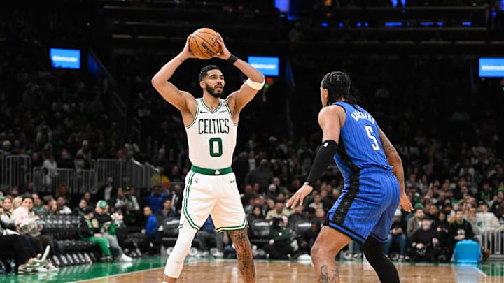 Jan 17, 2025; Boston, Massachusetts, USA; Boston Celtics forward Jayson Tatum (0) looks to pass the ball over Orlando Magic forward Paolo Banchero (5) during the second half at TD Garden. Mandatory Credit: Eric Canha-Imagn Images