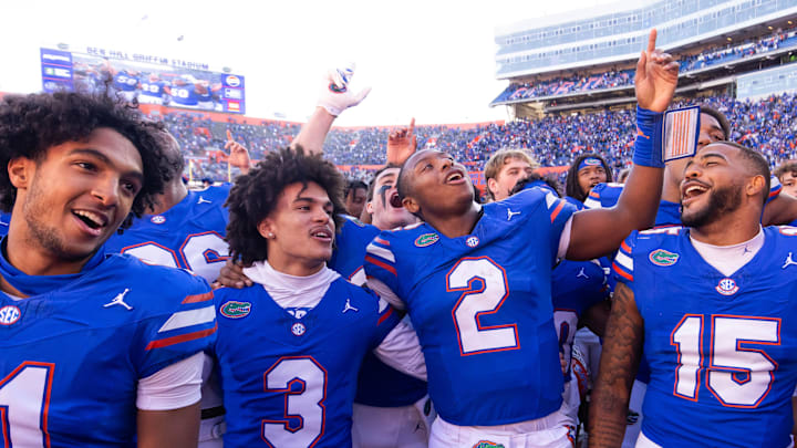 Florida Gators quarterback DJ Lagway (2) celebrates at Ben Hill Griffin Stadium with teammates Florida Gators running back Florida Gators wide receiver Aidan Mizell (11), Florida Gators wide receiver Eugene Wilson III (3) and Florida Gators linebacker Derek Wingo (15) in Gainesville, FL on Saturday, November 23, 2024. The Gators defeated the Rebels 24-17 [Doug Engle/Gainesville Sun]